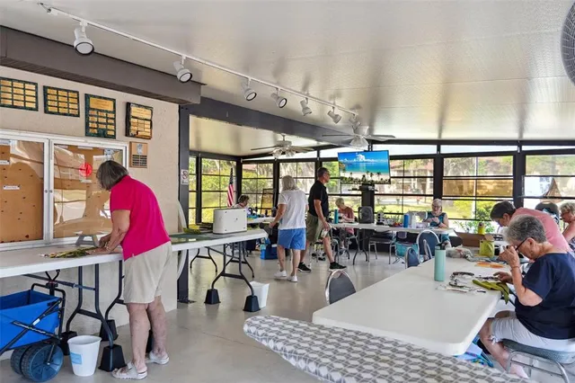 a living room with furniture a large window and a flat screen tv