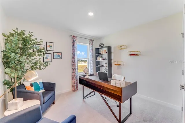a living room with furniture kitchen view and a chandelier