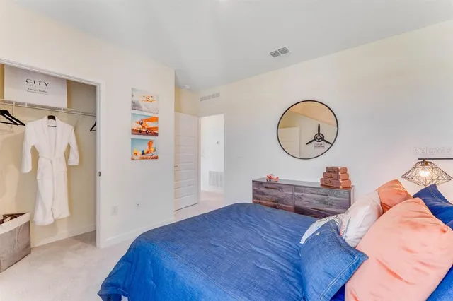 a bedroom with a bed and a dresser