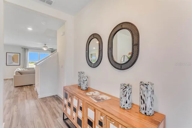 a dining room with furniture wooden floor and a rug