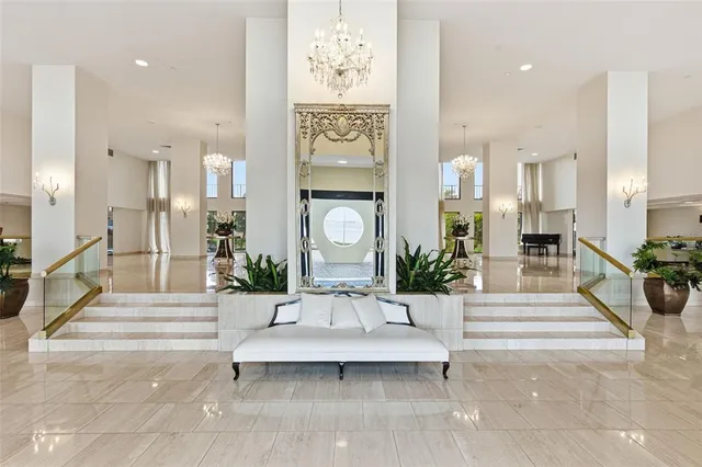 a living room with furniture and large windows