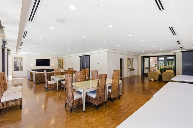a view of a patio with a table and chairs under an umbrella