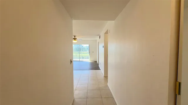 a view of hallway with bathroom