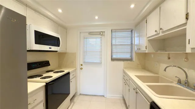 a kitchen that has a sink and a stove in it