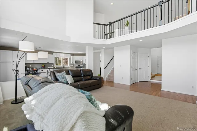 a living room with furniture and a ceiling fan