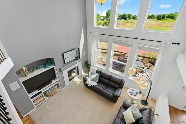 a living room with furniture tv and a fireplace