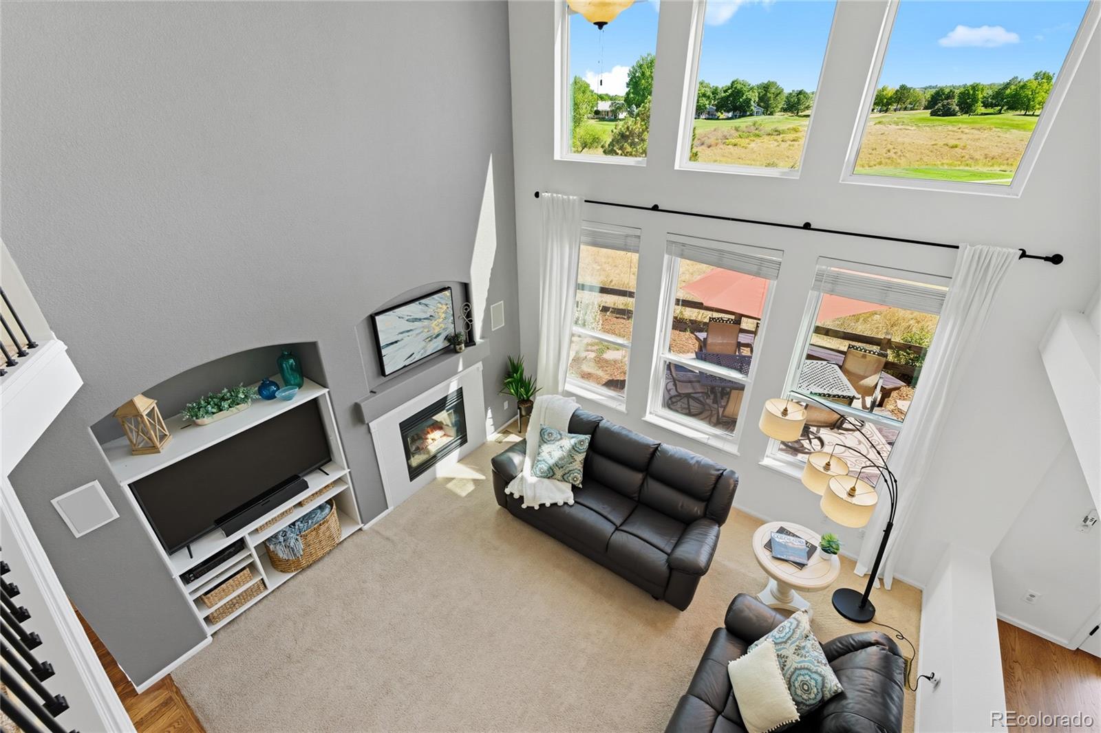 5126 Tuscany Court Highlands Ranch, CO 80130 - Photo 22 of 50 a living room with furniture tv and a fireplace