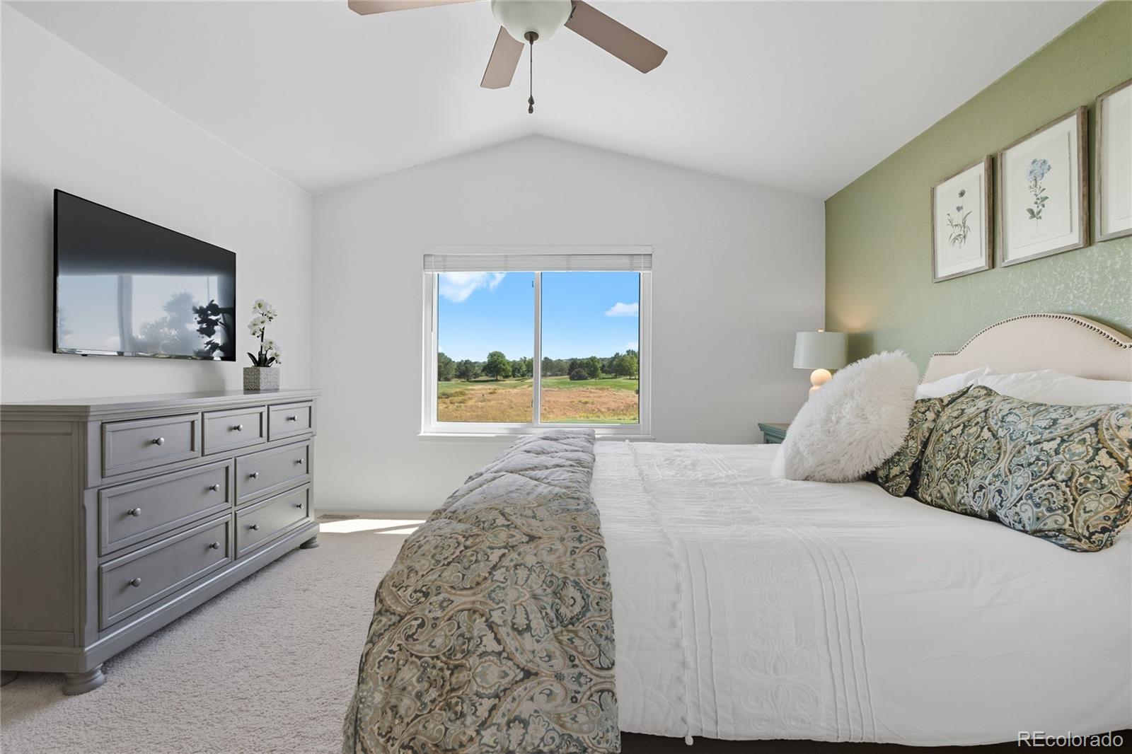 5126 Tuscany Court Highlands Ranch, CO 80130 - Photo 25 of 50 a bedroom with a large bed and a flat tv screen on dresser
