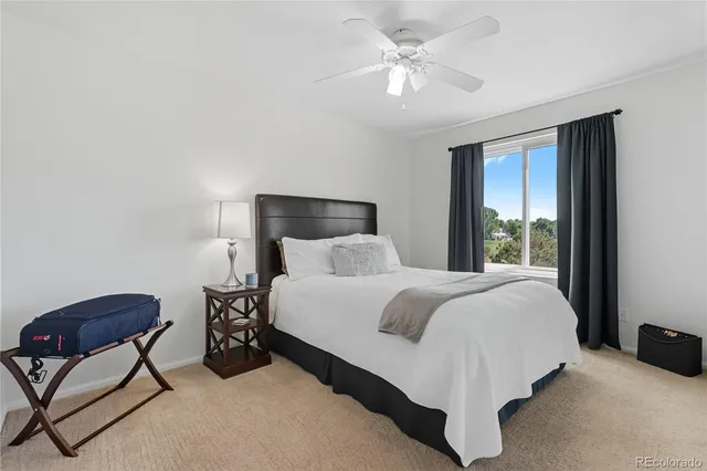 a bed room with a bed and a chair