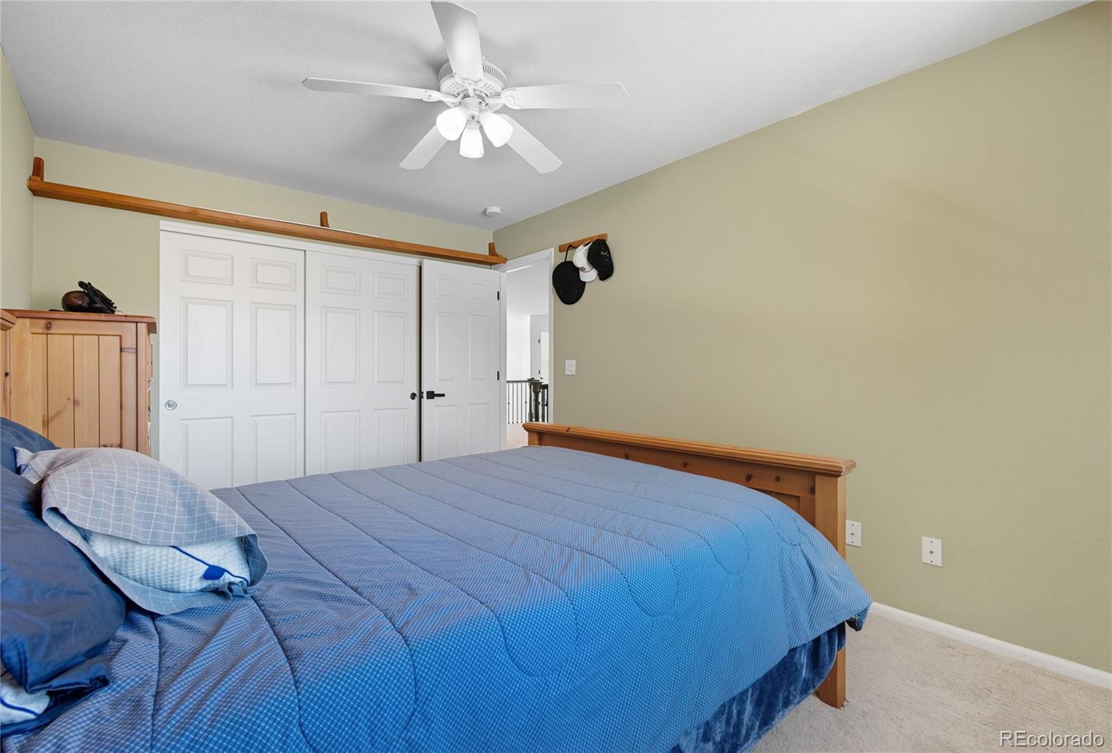 5126 Tuscany Court Highlands Ranch, CO 80130 - Photo 31 of 50 a bedroom with a bed and a chandelier