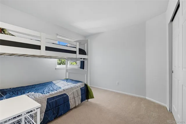 a bedroom with bed and cabinets