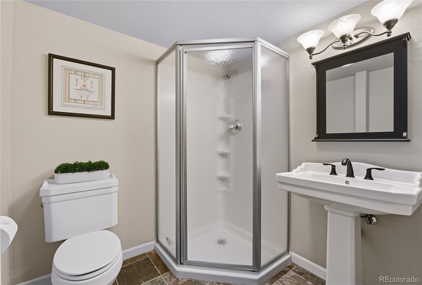 5126 Tuscany Court Highlands Ranch, CO 80130 - Photo 39 of 50 a bathroom with a toilet a sink a mirror and vanity