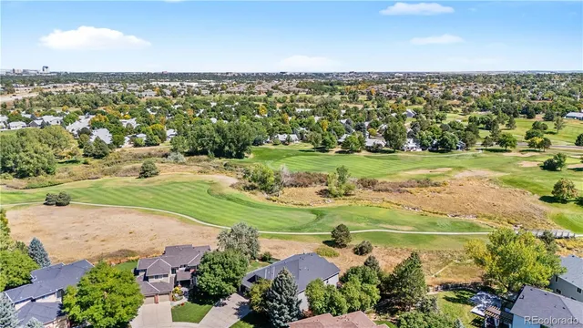 an aerial view of a house with yard and green space