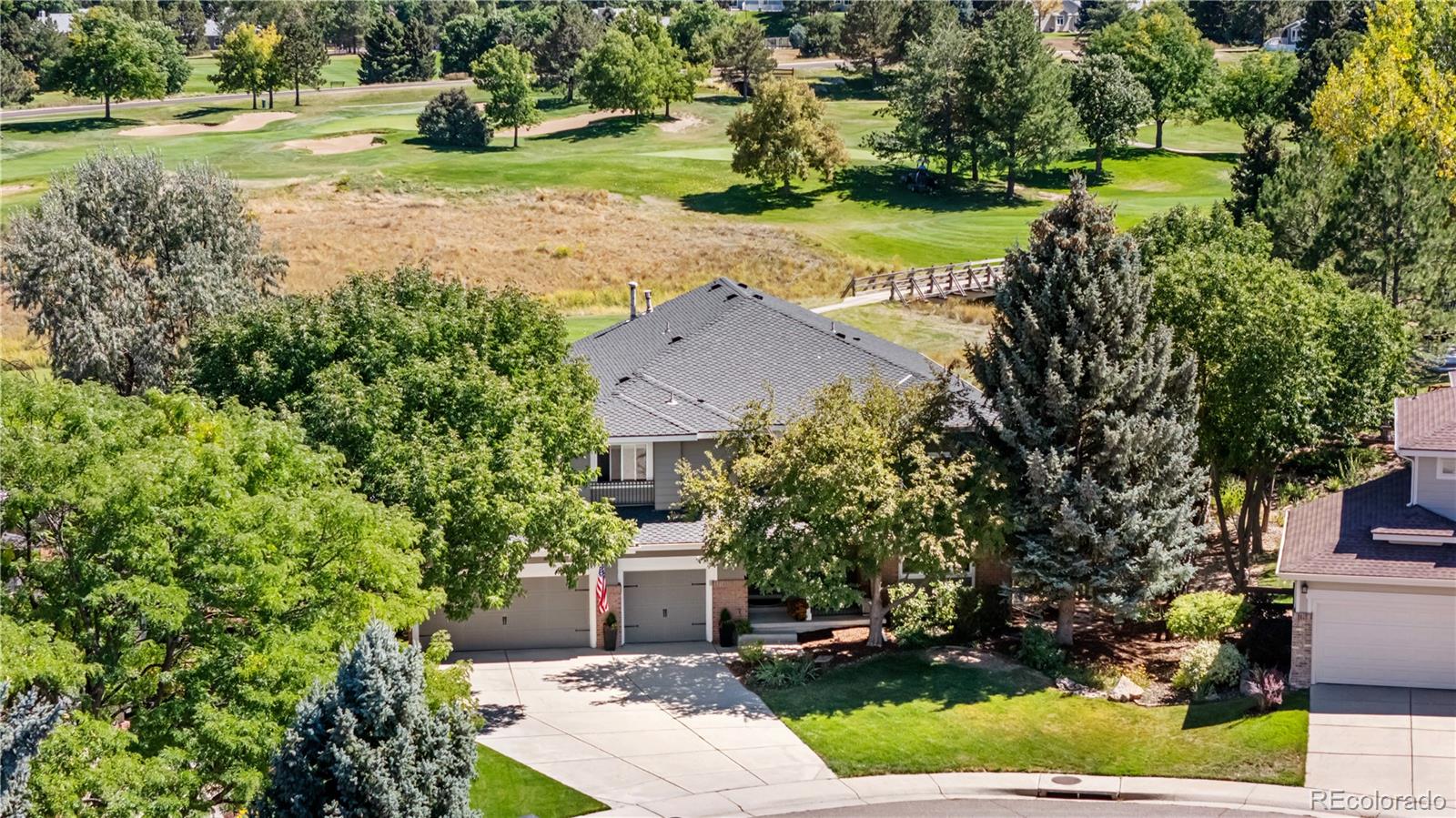 5126 Tuscany Court Highlands Ranch, CO 80130 - Photo 45 of 50 an aerial view of a house with yard and green space