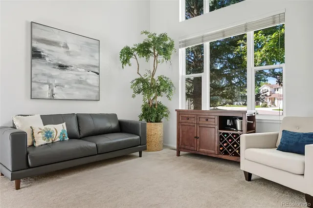 a living room with furniture and a potted plant