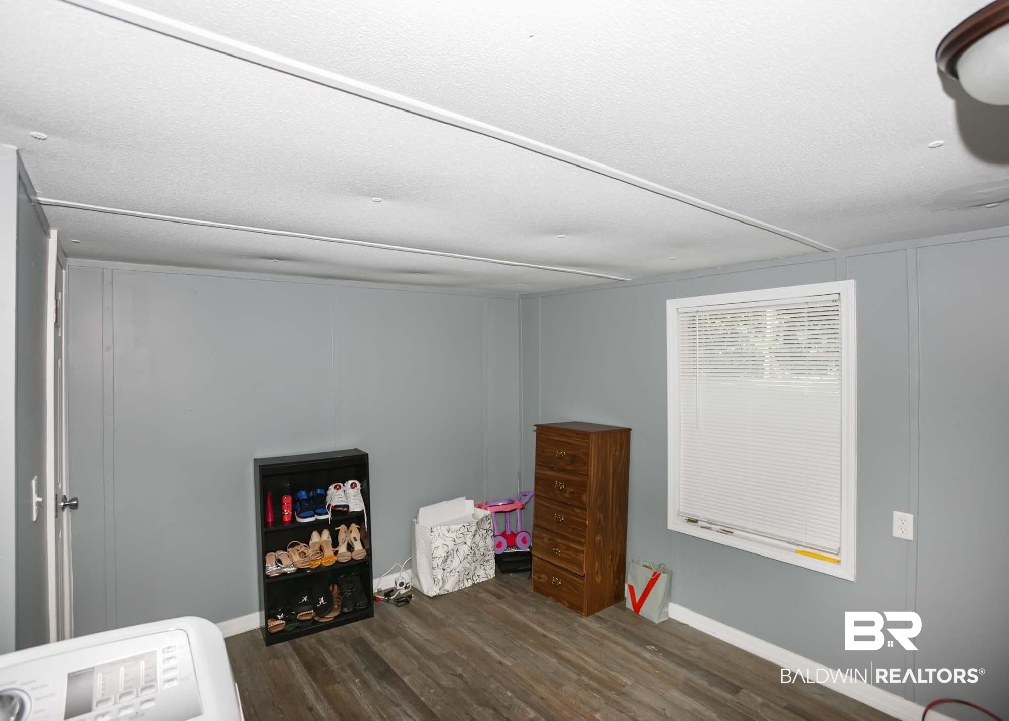 11998 Workman Avenue Foley, AL 36535 - Photo 25 of 59 Bedroom with dark wood finished floors and washer / dryer