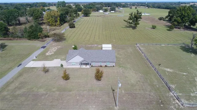 an aerial view of a house with a yard