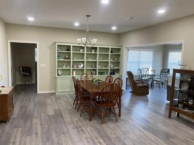 a view of a dining room with furniture and wooden floor