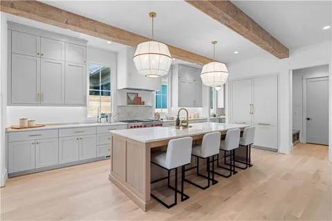 an open kitchen with cabinets a sink and a stove