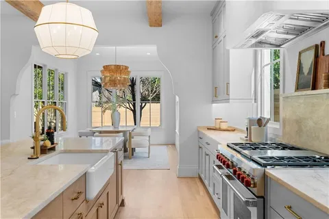 a living room with furniture fireplace and large windows