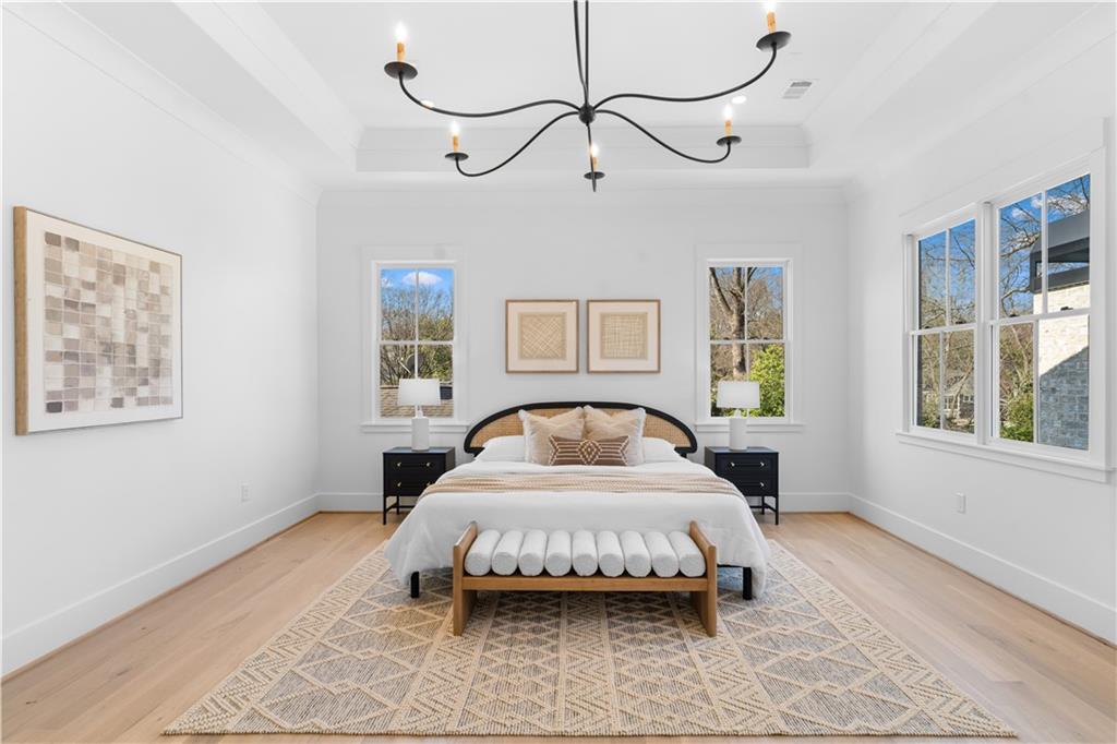 1140 Rosedale Drive Northeast Atlanta, GA 30306 - Photo 23 of 41 a spacious bedroom with a bed painting on wall and windows