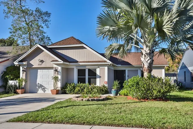 a front view of a house with a garden