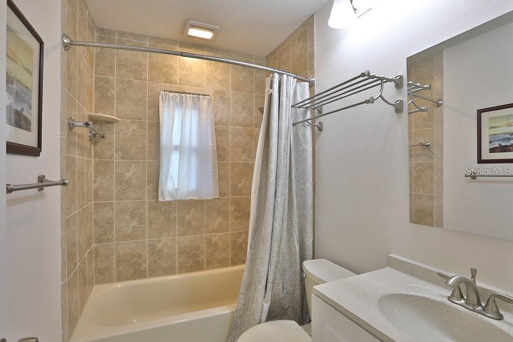 7920 George Washington Lane Tampa, FL 33637 - Photo 5 of 6 a bathroom with a granite countertop sink toilet and shower