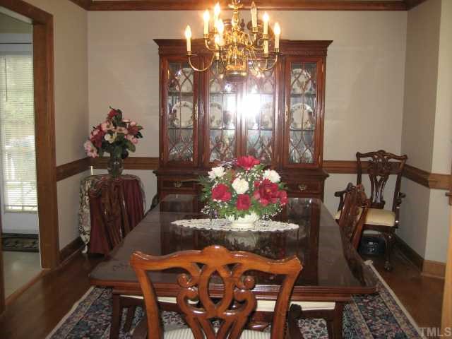 8605 Cheerful Court Raleigh, NC 27615 - Photo 3 of 12 a view of a dining room with furniture and chandelier