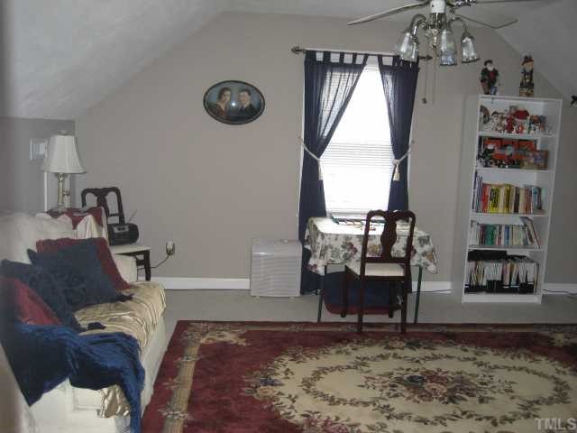 8605 Cheerful Court Raleigh, NC 27615 - Photo 6 of 12 a living room with furniture and a chandelier