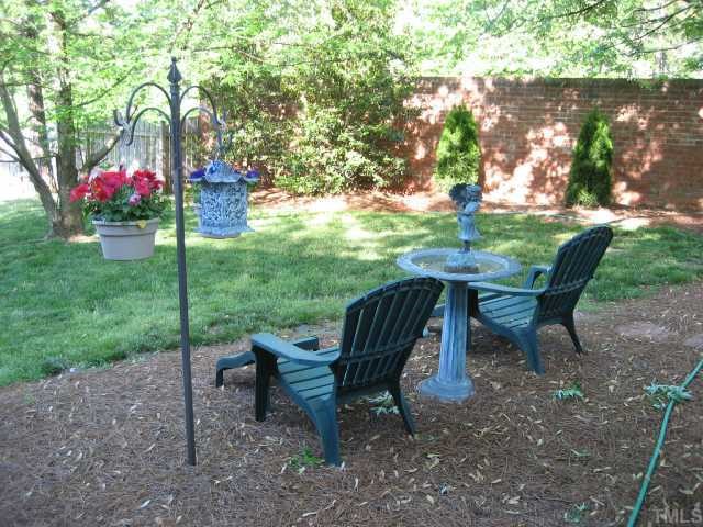 8605 Cheerful Court Raleigh, NC 27615 - Photo 8 of 12 a view of a table and chairs in the garden