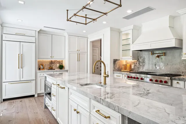 a kitchen with stainless steel appliances granite countertop a stove and a refrigerator