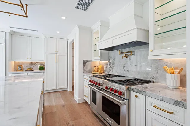 a large kitchen with stainless steel appliances lots of counter space sink and wooden floor