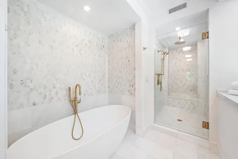 a bathroom with a bathtub and shower