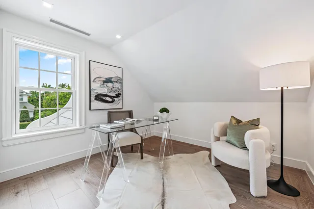 a spacious bedroom with a bed and a large window