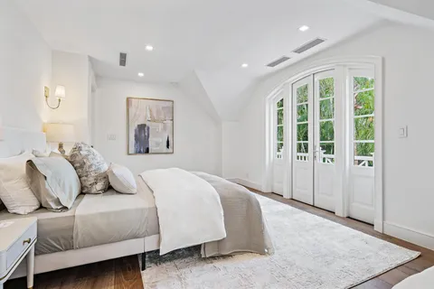 a en suite bathroom with a granite countertop sink mirror and shower