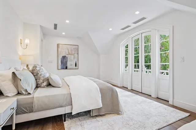 a en suite bathroom with a granite countertop sink mirror and shower