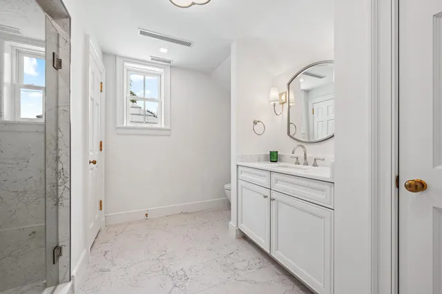 a large bedroom with a bed and wooden floor