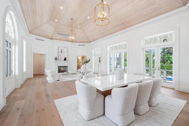 a living room with furniture a chandelier and a dining table