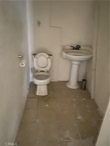 a white toilet sitting next to a bathroom sink