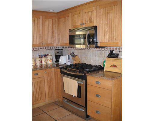 86 Ritch Avenue Greenwich, CT 06830 - Photo 5 of 13 a kitchen with stainless steel appliances granite countertop a stove and a microwave