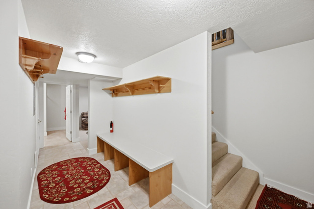 11192 Maple Road, Unit 7 Heber City, UT 84032 - Photo 29 of 51 Entryway featuring tiled flooring, built-in wooden shelving, and a built-in bench