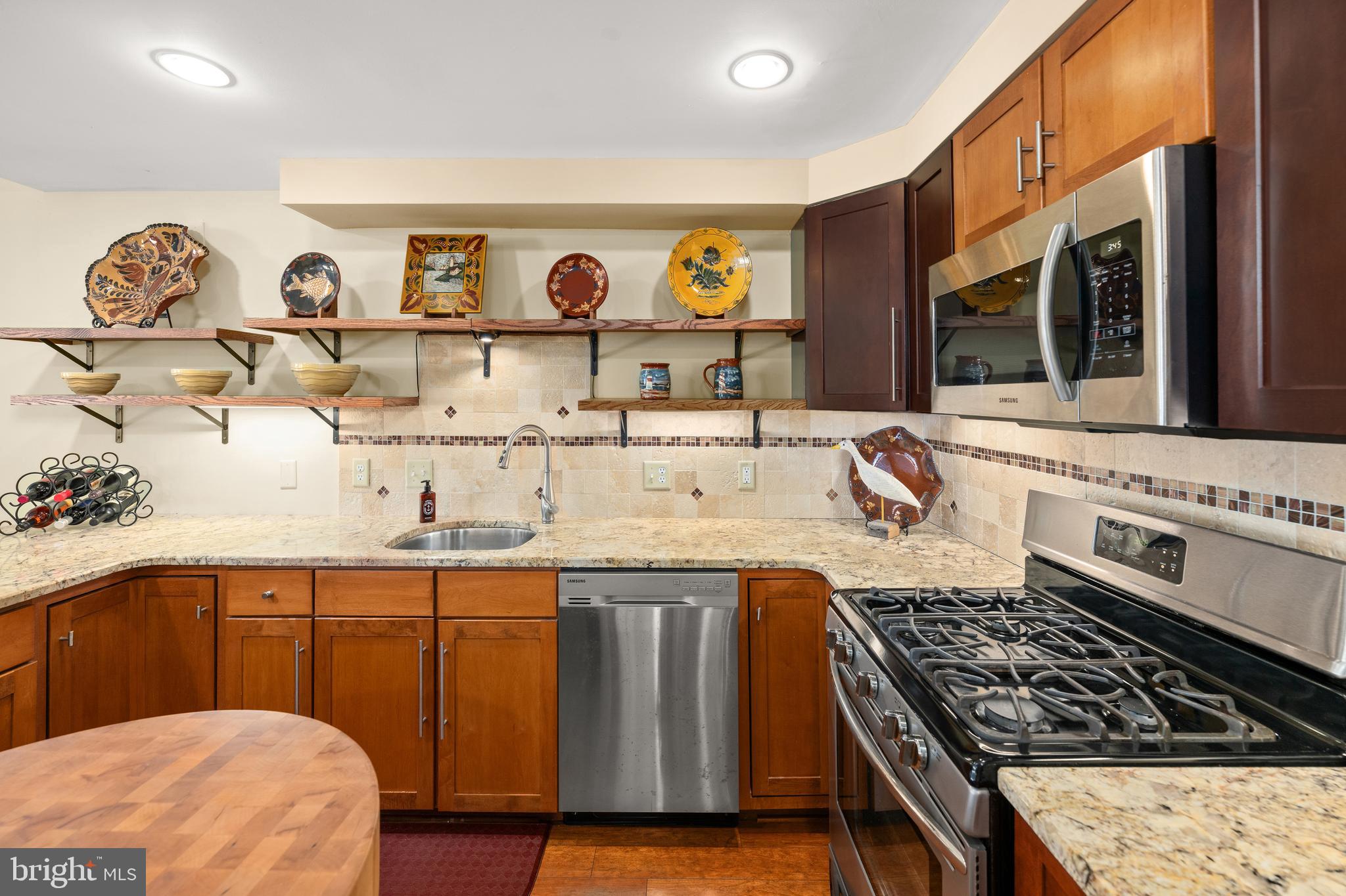 110 Anglers Road, Unit 206 Lewes, DE 19958 - Photo 13 of 40 a kitchen with stainless steel appliances granite countertop a stove and a sink