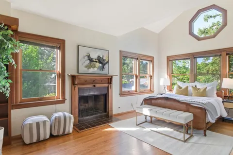 a spacious bedroom with a bed and a fireplace