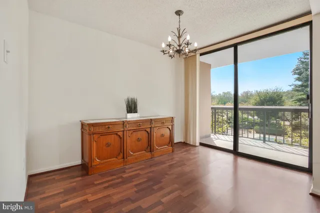 a view of a room with wooden floor and fan