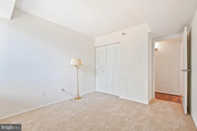 a spacious bedroom with a bed and a window