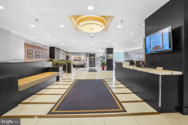 a lobby with furniture and a rug