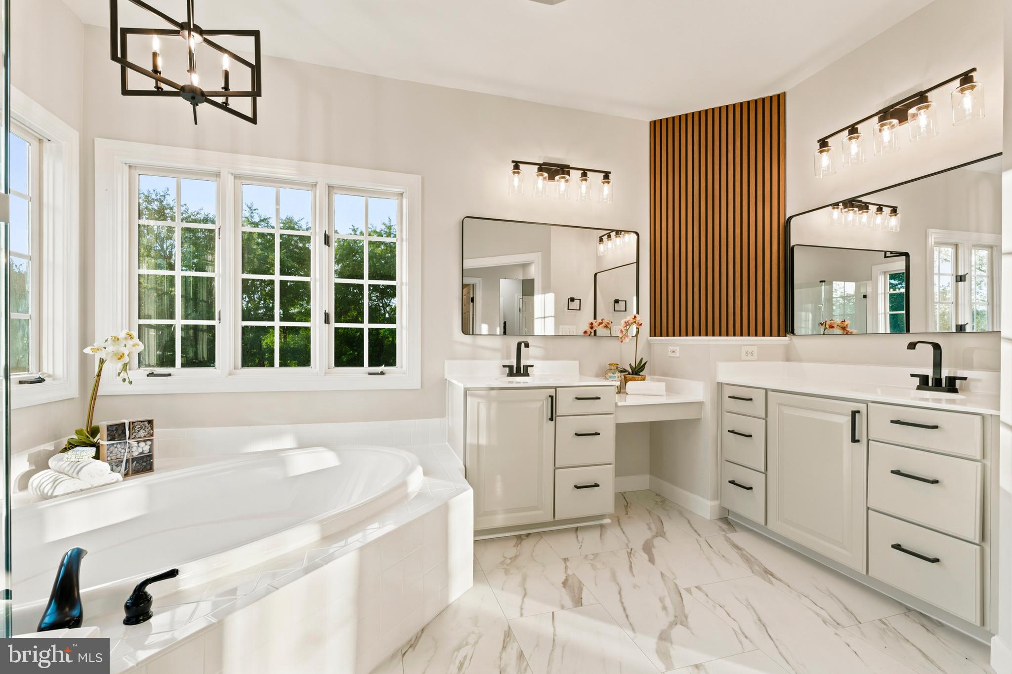 9313 Harrisons Farm Way Laytonsville, MD 20882 - Photo 39 of 77 a spacious bathroom with a double vanity sink a mirror a bathtub and next to a window