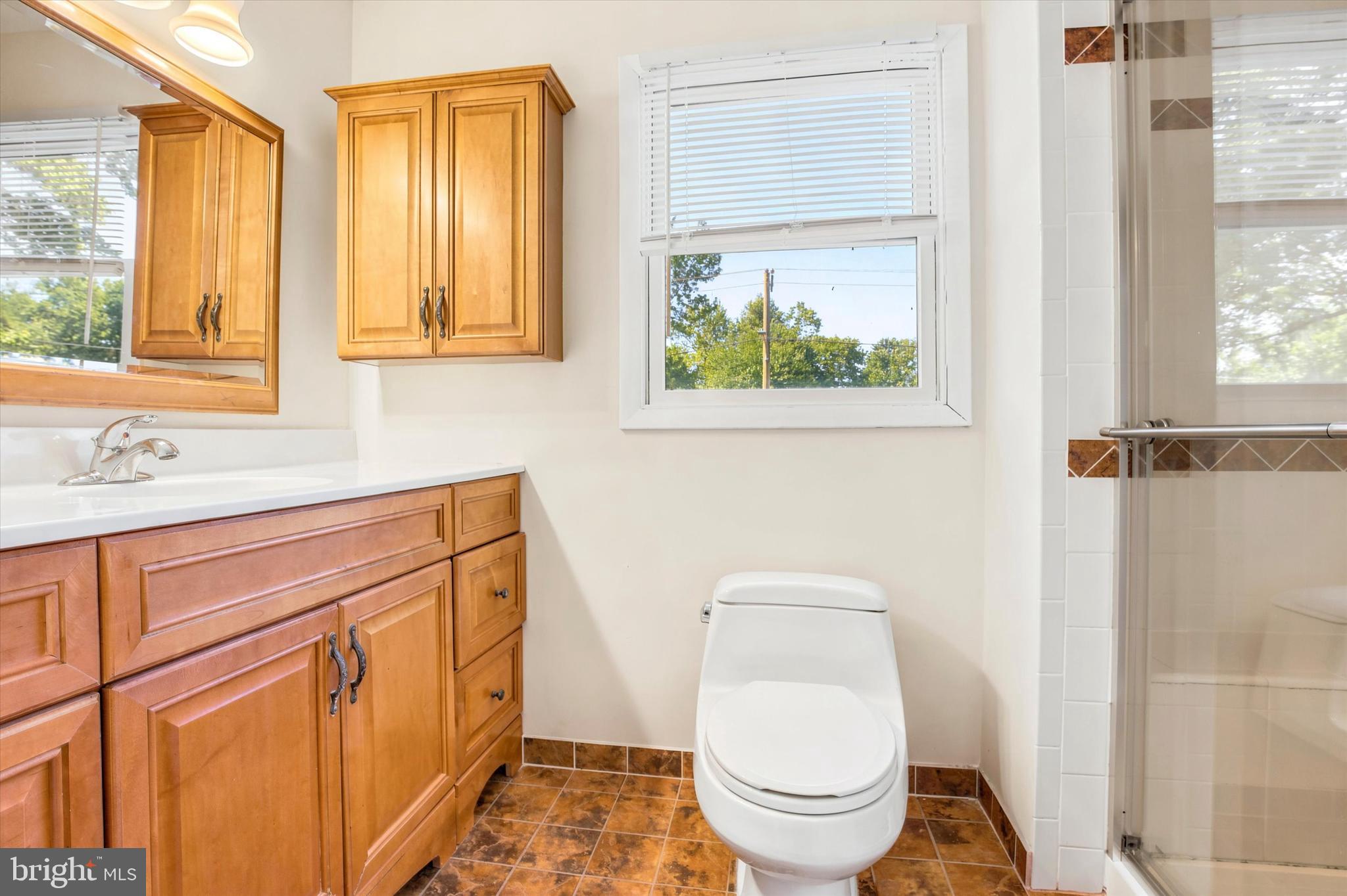 1167 Cushmore Road Southampton, PA 18966 - Photo 17 of 25 a bathroom with a toilet a sink and a window