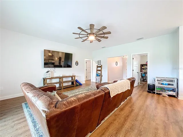 a bedroom with bed and wooden floor