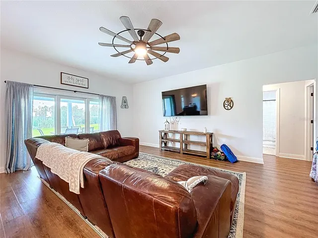 a kitchen with kitchen island granite countertop a sink cabinets and wooden floor